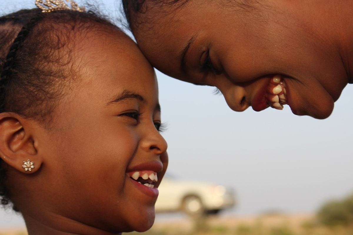 A parent and child laughing together